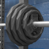 Four PU pro Olympic weight plates on barbell