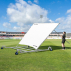 Man adjusting white mesh cricket sight screen