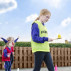 Young girl competing in egg and spoon race
